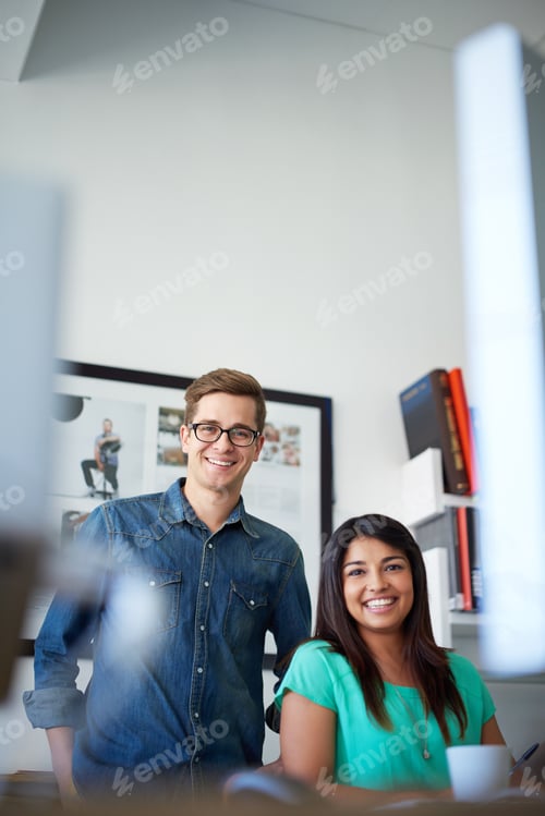 Preview: They make a great team. Cropped portrait of two designers in their office.