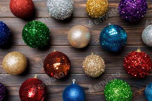 Vista previa: Top view of creative holiday baubles on wooden background. Christmas ornament concept
