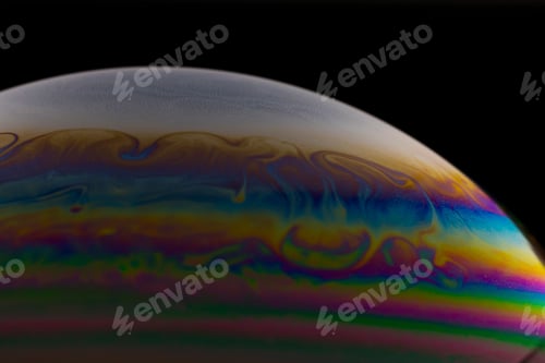 Preview: Macro shot of a colorful soap bubble on a dark background