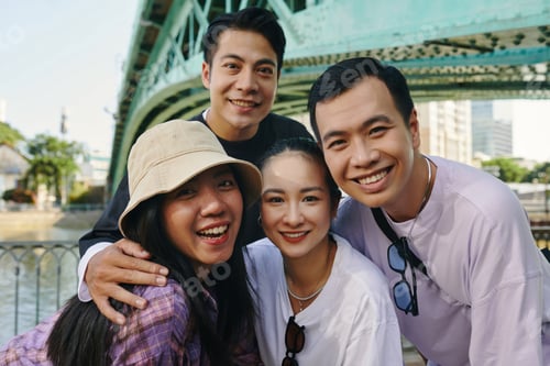 Preview: Group of Friends Hugging and Smiling Outdoors
