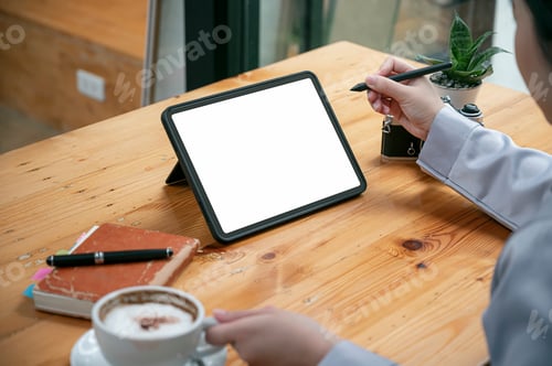 Preview: Cropped shot of woman hand working on portable tablet at office.