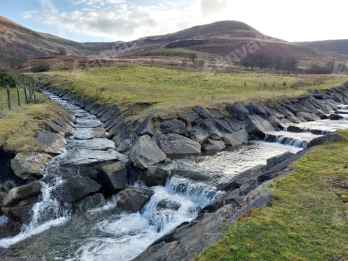 Preview: two manmade streams meeting at bottom of hills