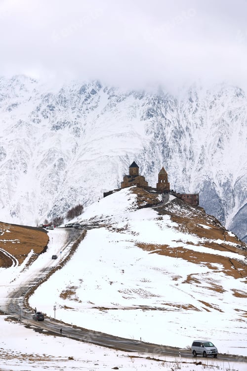 Preview: Snow-covered mountains in the backdrop of the Gergeti Trinity Church in Stepantsminda, Georgia