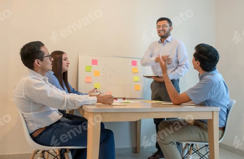 Preview: Team Meeting at Table with Presentation Board
