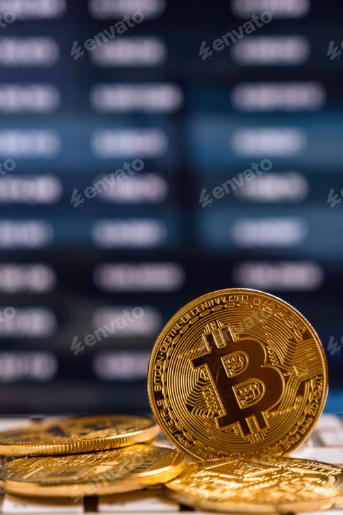 Preview: Closeup Bitcoins mockup on the keyboard over the cryptocurrency trading graph