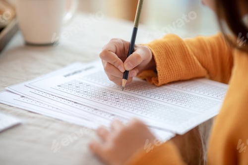 Preview: Girl in orange shirt doing a test