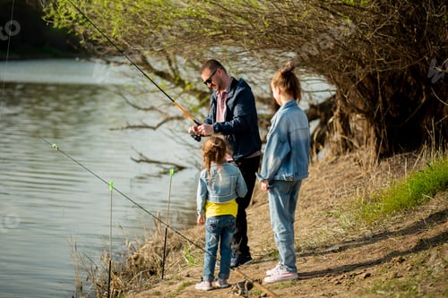 Preview: A dad and his two daughters are fishing in the river.
