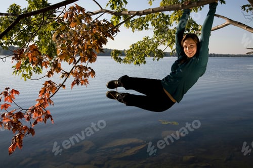 Preview: Woman swinging from tree