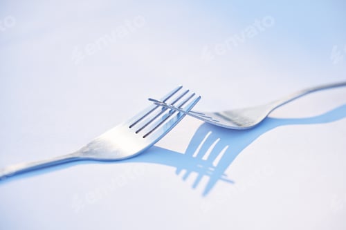 Preview: Dinner, shadow and forks on a table for partnership, teamwork and collaboration on a blue studio ba