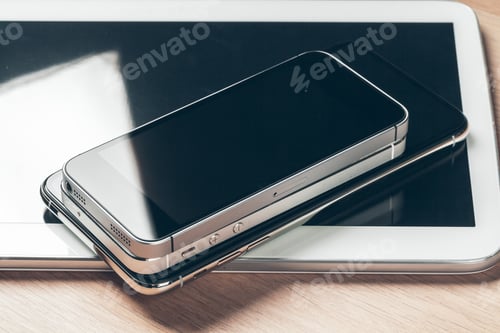 Preview: Digital tablet and mobile phone. Electronic devices on wooden table, close up