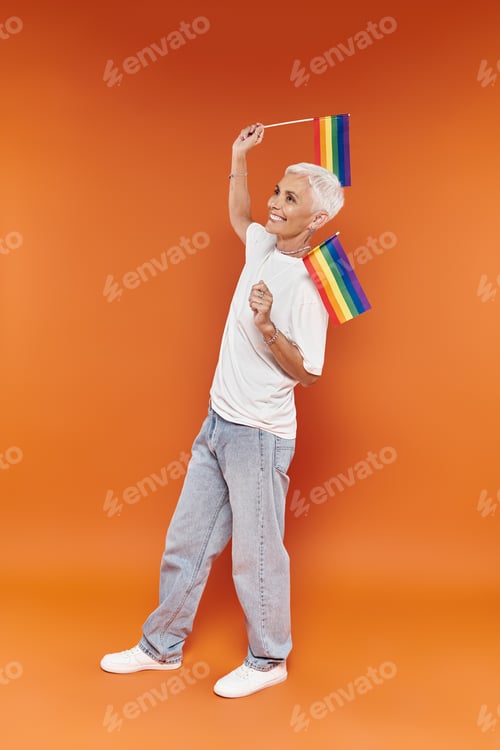 Preview: Joyful Celebration of Pride With Stylish Lesbian Holding Rainbow Flags
