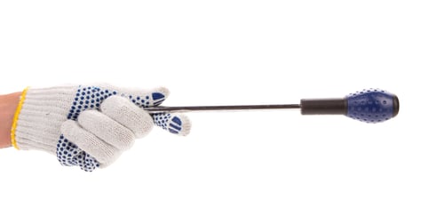 Preview: Hand in glove holding screwdriver.
