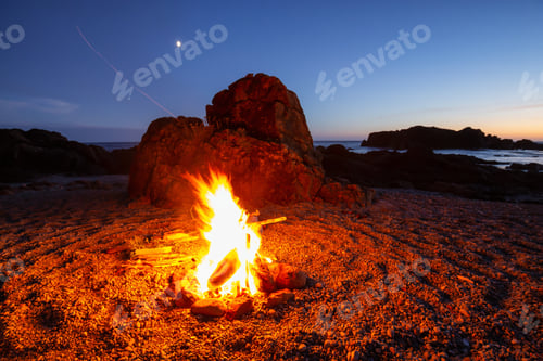 Preview: Camp fire on the beach during a vibrant summer sunset