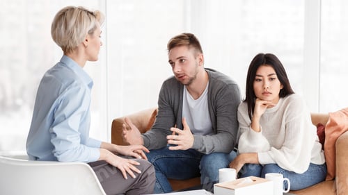 Preview: Spouses Talking With Counselor Discussing Family Problems Sitting In Office