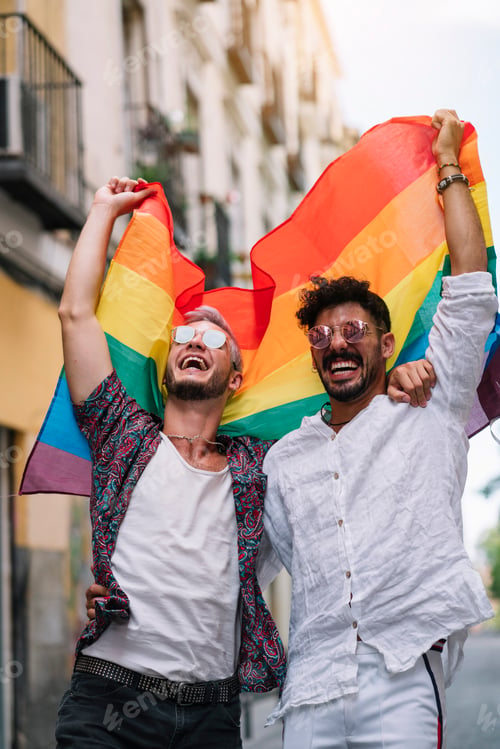 Preview: Couple boys with gay pride flag on the street of Madrid city