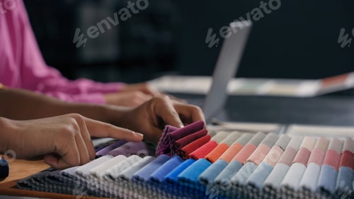 Preview: Close up hands fashion designer tailor choose textile samples cloth fabric collection. Cropped shot