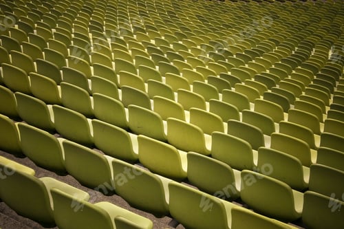Preview: Horizontal shot of the inside of an empty stadium with green chairs