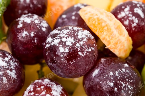 Preview: Grapes and orange on a fruit platter.
