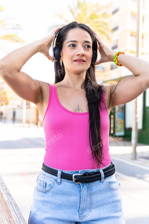 Preview: Happy woman listening to music while rollerblading in a residential area.