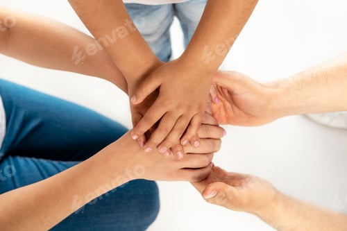 Preview: top view of parents putting hands together with daughter isolated on white