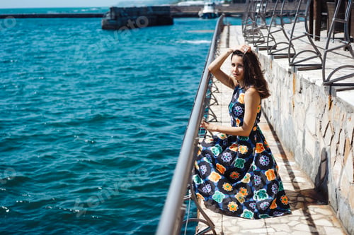 Preview: Young pretty woman on the pier near