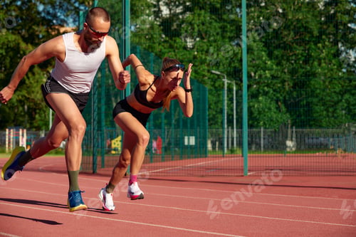 Preview: Woman and man jogging in the stadium