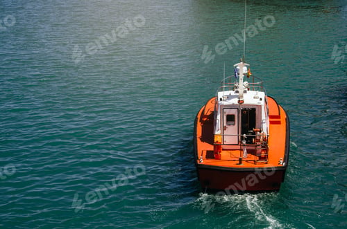 Preview: Orange and White Boat Sailing on Teal Water