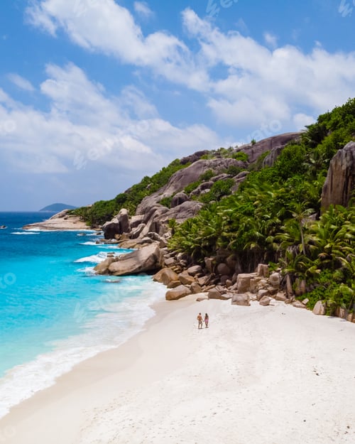Preview: Couple men and woman walking at a tropical beach, Drone view from above Seychelles Cocos Island
