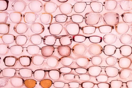 Preview: A lot of glasses on a pink background. Stylish fashionable background of rose-colored glasses