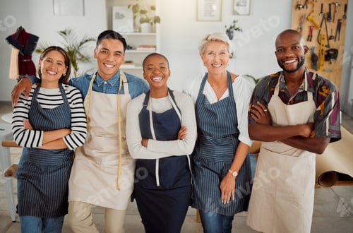 Preview: Portrait of a group of five cheerful diverse clothing designers standing with their arms crossed in