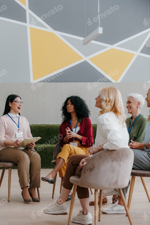 Preview: Mature women communicating and smiling while visiting group training class