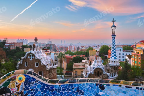 Preview: Barcelona city view from Guell Park. Sunrise view of colorful mosaic building in Park Guell