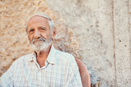 Preview: Portrait of a senior man sitting outside on the sidewalk of an ancient city