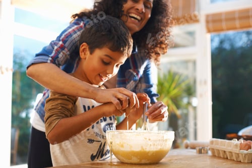Preview: Mother and son baking in kitchen