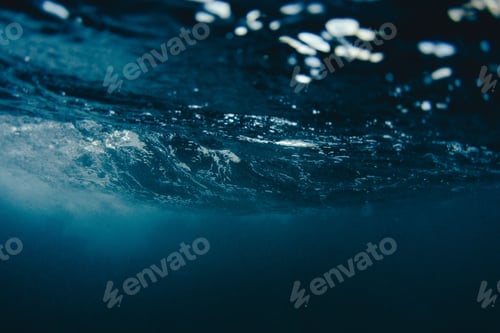 Preview: Beautiful view of splashing sea waves with seafoam at sunset
