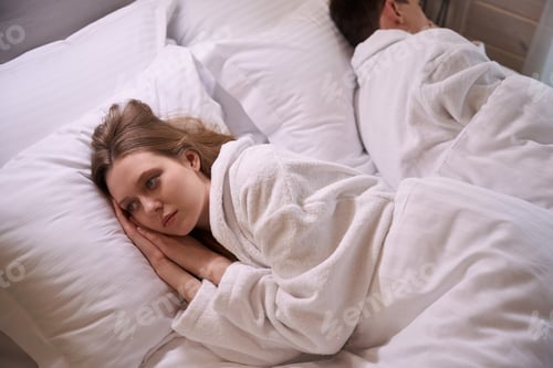 Preview: Lady in white dressing gown laying on pillow