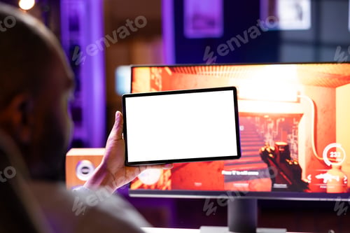 Preview: Player looking at isolated screen tablet, taking break from playing videogames