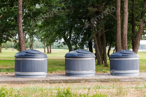 Preview: Modern trash cans round containers in park for separate collection of garbage