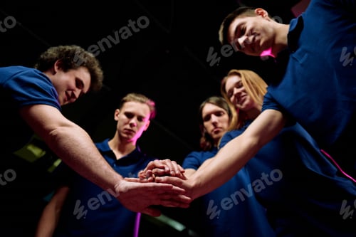 Preview: Team of five successful young e-sports clubbers making pile of hands