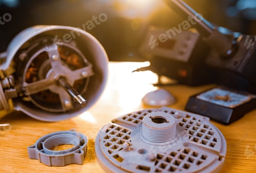 Preview: Close-up of iron motor from home cooling fan lies on a table