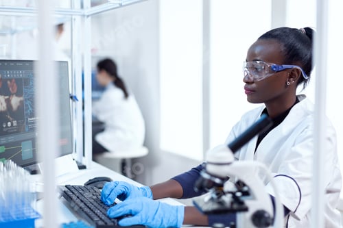 Preview: Professional medical worker typing information about virus study