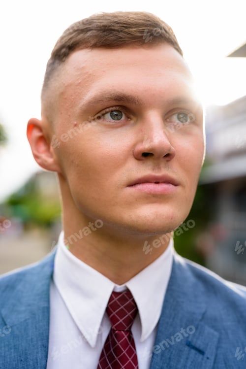 Preview: Portrait of young businessman in the streets outdoors