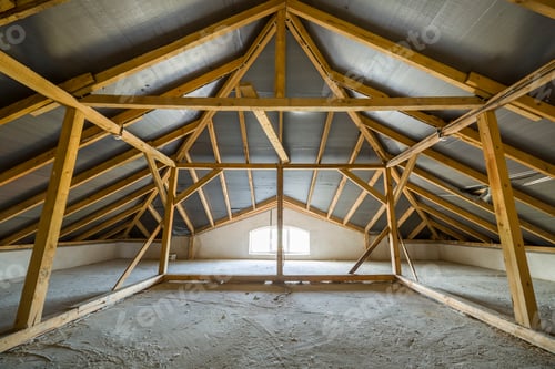 Preview: Attic of a building with wooden beams of a roof structure and a small window.