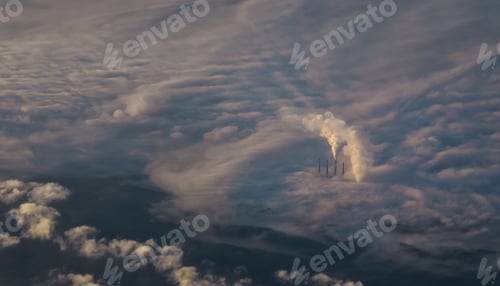 Preview: Aerial shot of a power station smoke high above in a sky covered with clouds