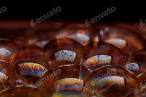 Preview: Abstract texture with bubbles. Rainbow soap bubble on a black background.