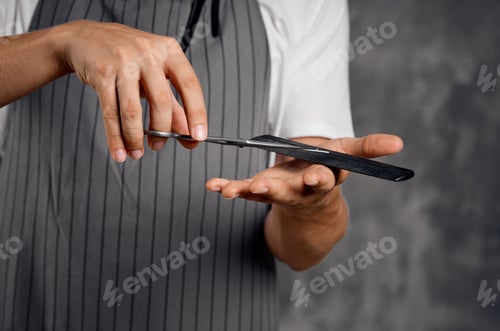 Preview: a man with a beard holds scissors and a comb in his hand hairdresser hair styling barbershop