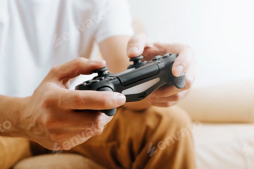 Preview: Close-up of man pushing buttons of wireless device of gamepad