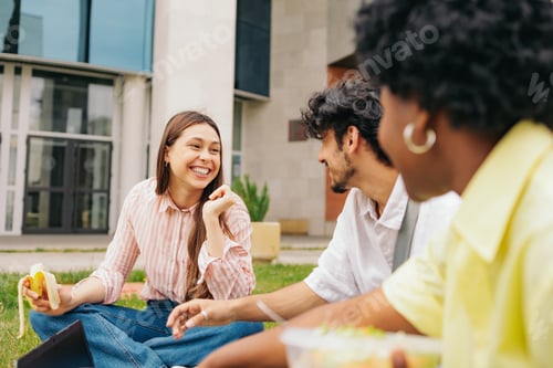 Preview: Latin college students sitting on campus having a conversation and smiling