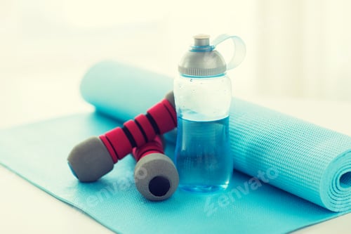 Preview: close up of bottle, dumbbells and sports mat