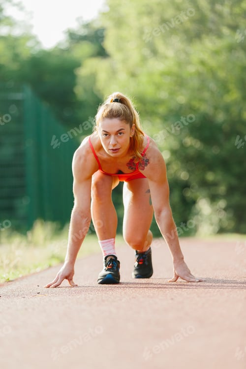 Preview: Female athlete preparing for running sprint on track